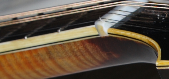 Notice how the headstock binding and neck binding are completely different colors and don't match at all?